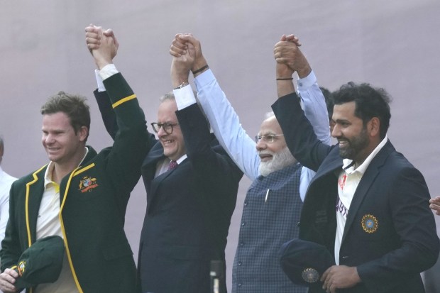 Prime Minister Narendra Modi with his Australian counterpart Anthony Albanese raise their hands with Indian and Australian cricket team captains Rohit Sharma, and Steven Smith at the start of the fourth cricket test match between India and Australia in Ahmedabad. (AP photo)