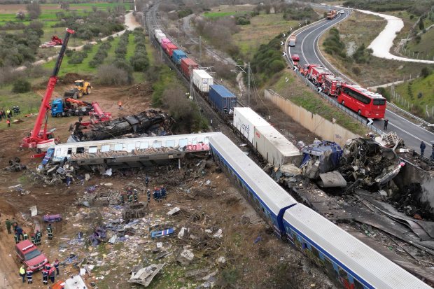 A crane, firefighters and rescuers operate after a collision in Tempe near Larissa city, Greece. (AP Photo)