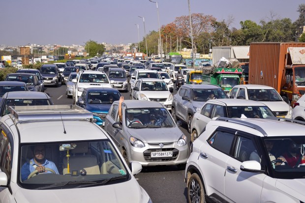 Vehicles are stuck in a heavy traffic jam on Delhi-Gurugram expressway near idol of Lord Shiva, in New Delhi. (Photo: PTI)