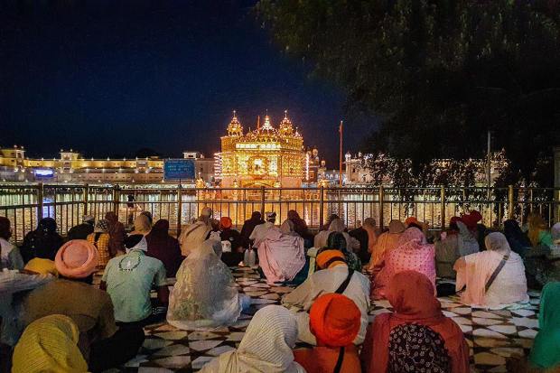 Amritsar: Golden Temple illuminated on the eve of the birth anniversary celebrations of the 9th Sikh Guru, Guru Tegh Bahadur, in Amritsar, Monday, April 10, 2023. (PTI Photo)(PTI04_10_2023_000208B)