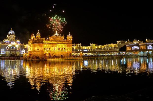 Amritsar: Fireworks at the illuminated Golden Temple on the occasion of the birth anniversary of Guru Arjan Dev, in Amritsar, Wednesday, April 12, 2023. (PTI Photo)(PTI04_12_2023_000277A)
