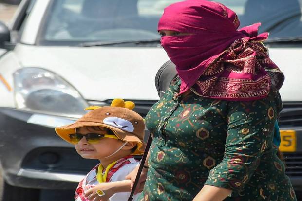 A woman and a child during a hot summer day, in Dehradun. (PTI)