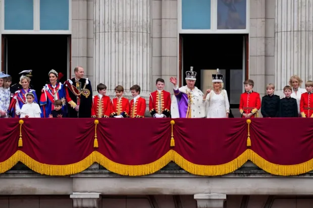 Britain's King Charles III and Queen Camilla wave to the crowds from the balcony of Buckingham Palace after their coronation ceremony.