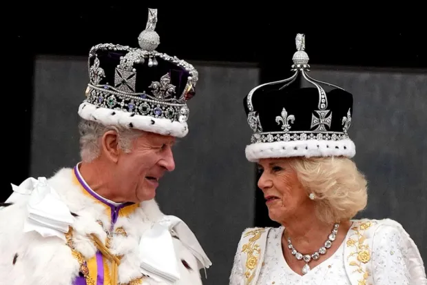Britain's King Charles III and Queen Camilla greet the crowds from the balcony of Buckingham Palace after the coronation ceremony in London on Saturday.