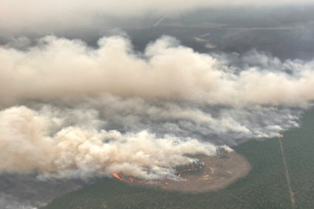 Smoke rises from wildfire EWF-031, part of the Pembina Wildfire Complex east of Minnow Lake near Edson, Alberta, Canada (Reuters)