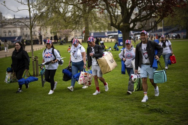 Royal fans walk with their belongings towards the King's Coronation route at The Mall in London, in London, Friday. (Photo: AP)