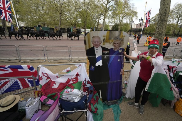Royal fans who have spent the night camping out along the Mall, part of the Coronation route, wake up and leave their tents in London on Friday. (Photo: AP)