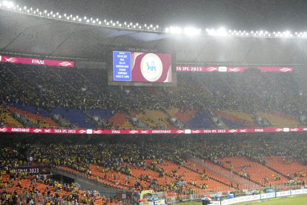 Fans look on as it rains before the start of Indian Premier league cricket final match between Chennai Super Kings and Gujarat Titans at the Narendra Modi stadium in Ahmedabad. (Image/AP)