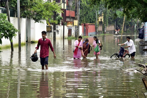 Guwahati: People wade through a waterlogged road after rainfall, in Guwahati, Saturday, June 17, 2023. (PTI Photo)