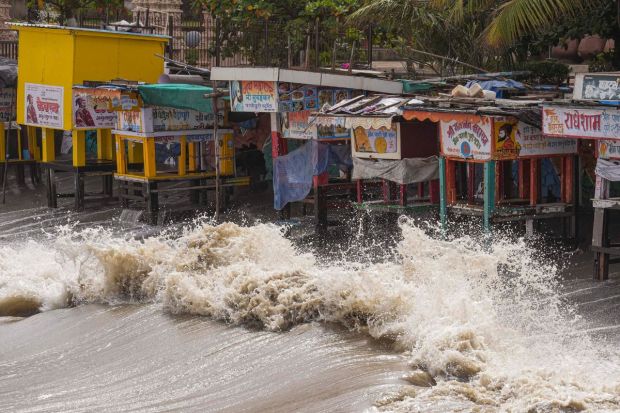 High waves crash against shops near the shore ahead of the landfall of Cyclone Biparjoy, in Mumbai. According to the meteorologists, the wind speed can go upto 125-135 km (78-84 miles) per hour. (Photo Credits: PTI)