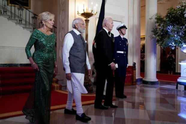 US President Joe Biden, first lady Jill Biden, and India's Prime Minister Narendra Modi walk in front of the Grand Staircase of the White House before an official state dinner. (Photo Credits: Reuters) 