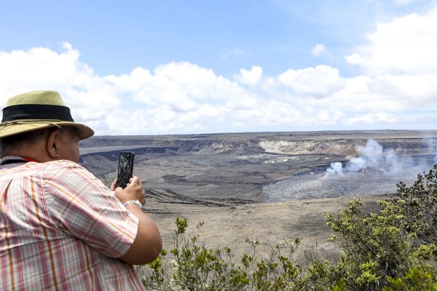 A visitor takes photos and videos of the Kilauea eruption in Hawaii on Wednesday, June 7, 2023. (Photo: AP)