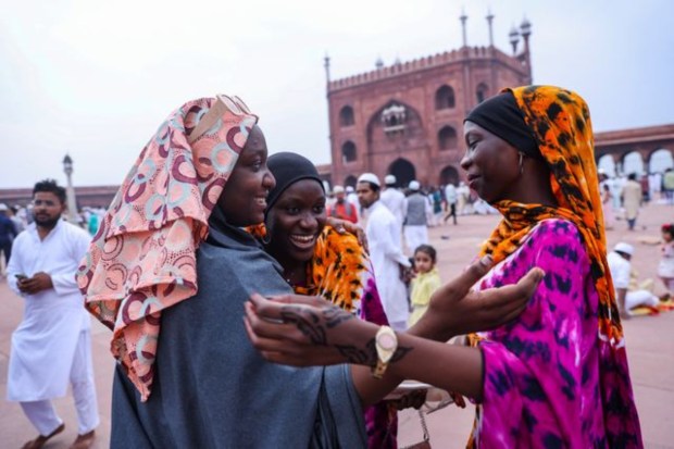 Nigerian Muslim women greet each other after offering prayers at Jama Masjid. (Image: Reuters)