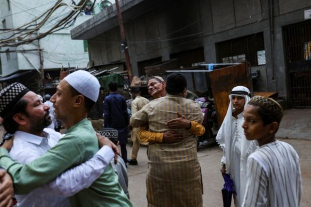 Men greet each other on the occasion of Eid al-Adha festival in Delhi. (Image: Reuters)