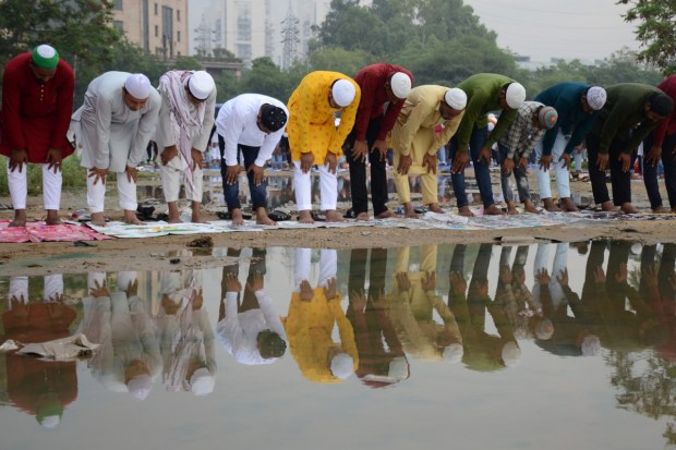 Men offer prayers on the occasion of Eid al-Adha festival, at Leisure Valley ground, in Gurugram. (Image: PTI)