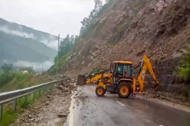 Heavy machinery being used to clear Rishikesh-Badrinath National Highway blocked with boulders after a rain-triggered landslide, in Rudraprayag district. (PTI Photo)