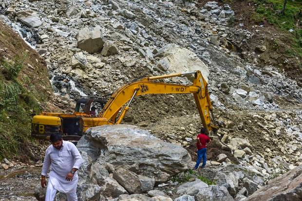 Rescue operation being carried out after a heavy landslide due to monsoon rains on a highway near Yamunotri Temple, in Uttarkashi district. (PTI Photo)