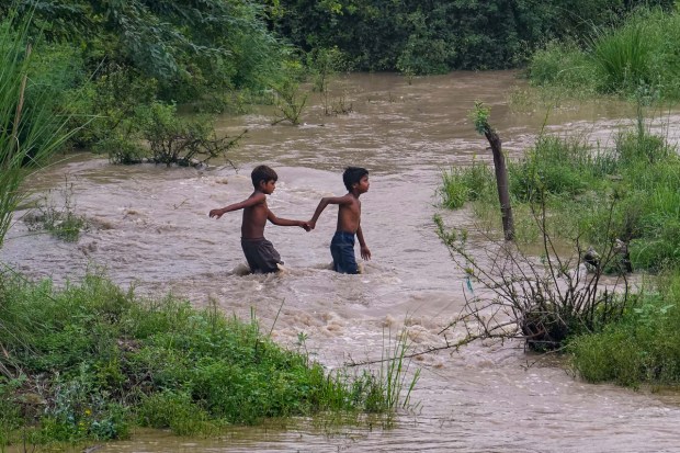 Children play in floodwaters in New Delhi. (Image: PTI)