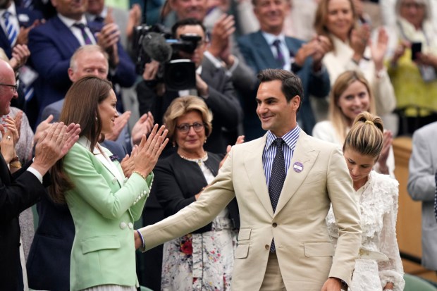 Roger Federer in the Royal Box next to Princess Kate is applauded at Centre Court ahead of play on day two of the Wimbledon tennis championships in London. (Image: AP)
