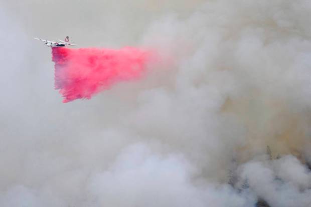 A tanker makes a retardant drop over the Highway Fire near Washington, California. (AP)