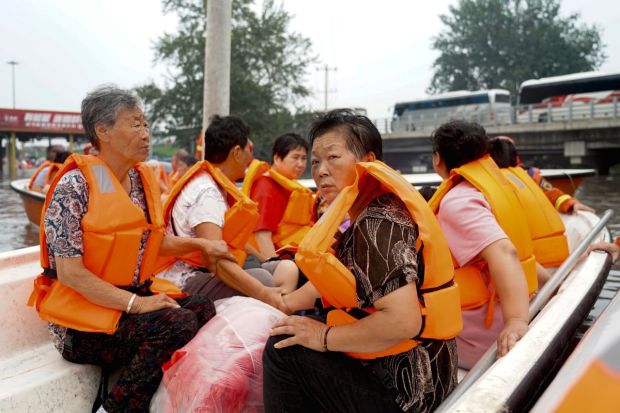 Residents being evacuated by rubber boats through flood waters in Zhuozhou in northern China's Hebei province, south of Beijing. China's capital has recorded its heaviest rainfall in at least 140 years over the past few days. The province of Heilongjiang to the north, was evacuating entire villages in anticipation of life-threatening deluges. Rescue work remains underway. (AP Photo)