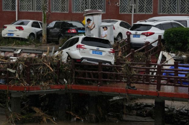 Rescuers using rubber boats evacuate trapped residents through flood waters in Zhuozhou, south of Beijing. Beijing usually has dry summers, but had a stretch of record-breaking heat this year that broke dramatically over the weekend with almost a week of constant rain and drizzle. Power was knocked out in areas, public transport and summer classes were suspended and citizens of the metropolis of more than 20 million were told to stay home. (AP Photo)