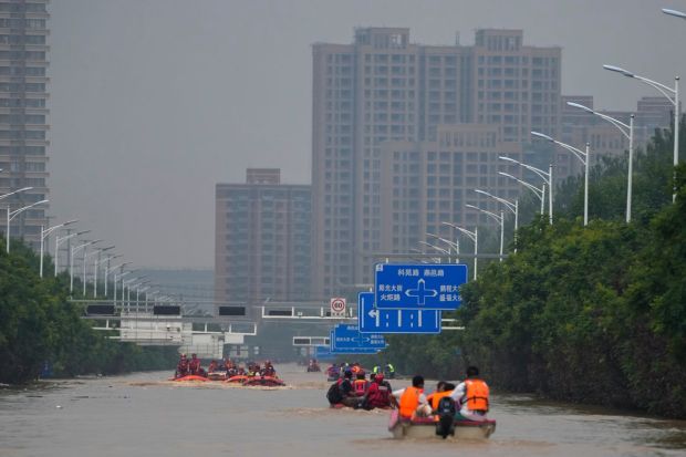 Trapped residents being rescued by boat in the flood-hit Fangshan district on the outskirts of Beijing on Wednesday. At least 20 people have been reported killed in Beijing’s outer suburbs and another 27 were missing following the weekend storms that quickly overwhelmed drainage systems. (AP Photo)