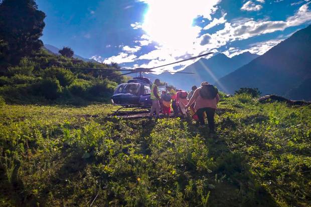 People stuck in Madmaheshwar valley due to rains being rescued by a helicopter, in Rudraprayag district. (PTI Photo)