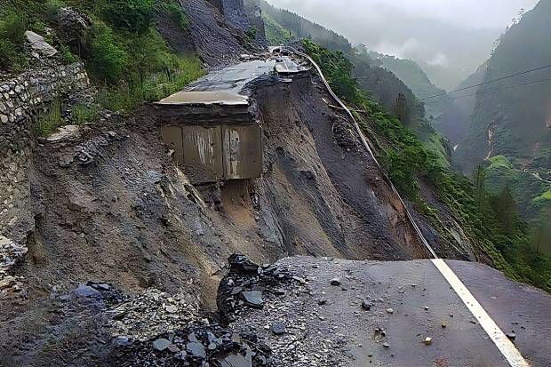 A section of a road on the Badrinath National Highway near Bhanerpani Pipalkoti washed away following heavy rainfall, in Chamoli district. (PTI Photo)