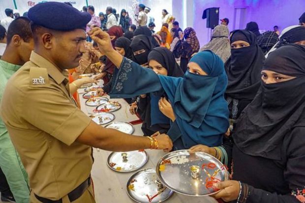 Muslim women tie 'rakhi' to police officials on Raksha Bandhan, in Thane. (PTI Photo) 