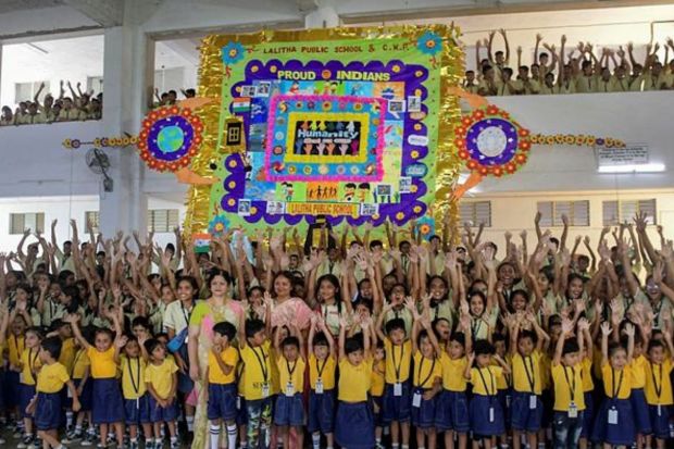 School children display a huge 'rakhi' created by them ahead of 'Rakhsha Bandhan' festival in Nagpur on Tuesday. (PTI Photo)