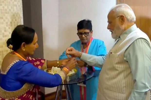 A women tie ‘Rakhi’ to Prime Minister Narendra Modi in Johannesburg on August 22 ahead of Raksha Bandhan. (PTI Photo)