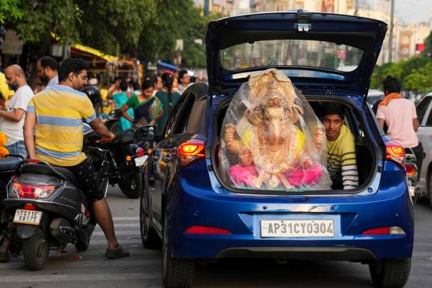 Devotees transport an idol of the elephant-headed Hindu god Ganesha to a place of worship on the eve of Ganesh Chaturthi festival in Hyderabad, India. (AP Photo)