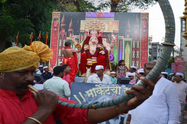 Devotees carry an idol of Lord Ganesha to a pandal for the Ganesh Chaturthi festival, in Karad. (PTI Photo)