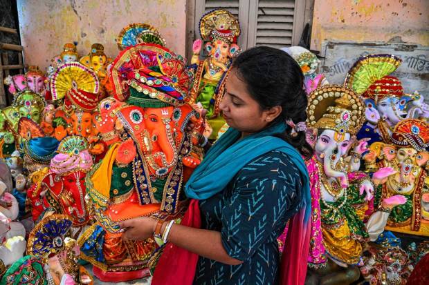 An artist displays idols Lord Ganesha put on sale ahead of the 'Ganesh Chaturthi' festival, in Kolkata. (PTI Photo)