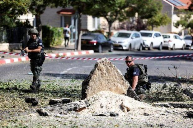 Israeli security personnel inspect the site where a rocket launched from the Gaza Strip fell, in Mevaseret Zion, Israel. (Image/Reuters)