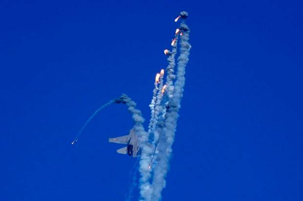 An Indian Air Force fighter aircraft Sukhoi Su-30 fires flares during Air Force Day celebrationS at Sangam, the holy confluence of river Ganga, Yamuna and the mythical Saraswati, in Prayagraj.(AP Photo)