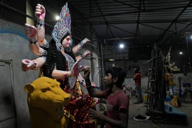 An artisan prepares a clay idol of Hindu Goddess Durga ahead of Durga Puja festival in Hyderabad. (AP Photo)