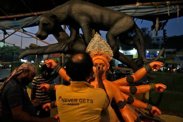 An artisan prepares a clay idol of Hindu Goddess Durga ahead of Durga Puja festival in Hyderabad. (AP Photo)