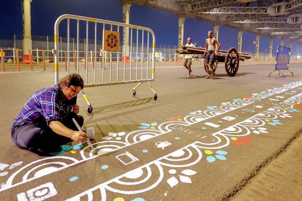Art students prepare 'rangoli' on the Howrah bridge ahead of Durga Puja festival, in Kolkata. (PTI Photo)