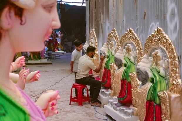 An artisan gives final touches to an idol of Goddess Durga ahead of Durga Puja festival, in Karad. (PTI Photo)
