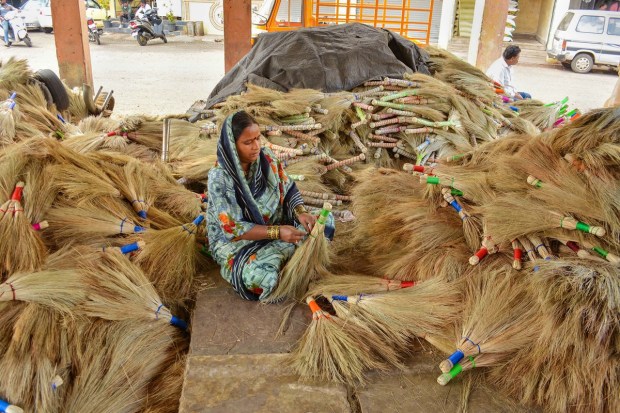 A vendor makes brooms for sale ahead of Diwali festival, in Karad. (PTI Photo)