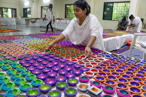 Children from an orphanage arrange 'diyas' made by them for sale ahead of Diwali festival, in Nagpur. (PTI Photo)