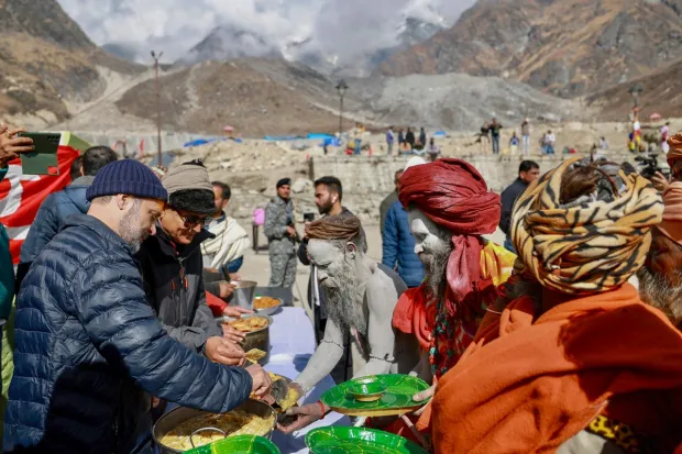 Gandhi interacted with the ash-smeared sadhus and served tea to the devotees. He inquired about their journey and any problems they faced.(PTI Photo)