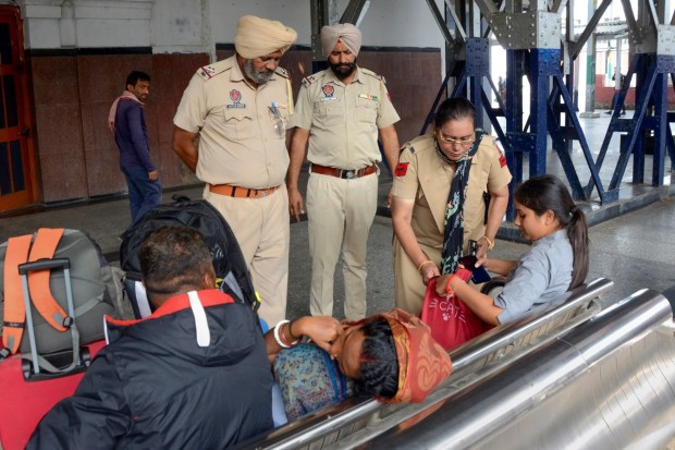 Punjab Police personnel check the luggage of a passenger at a railway station as part of security measures ahead of Diwali, in Amritsar. (PTI Photo)