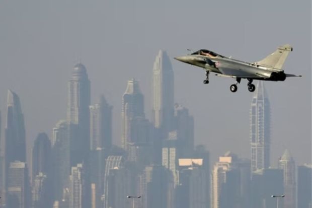 The skyline of the city is seen on the background as a French Air Force Dassault Rafale C jet fighter prepares to land during the opening day of the Dubai Air Show, Monday.(AP)