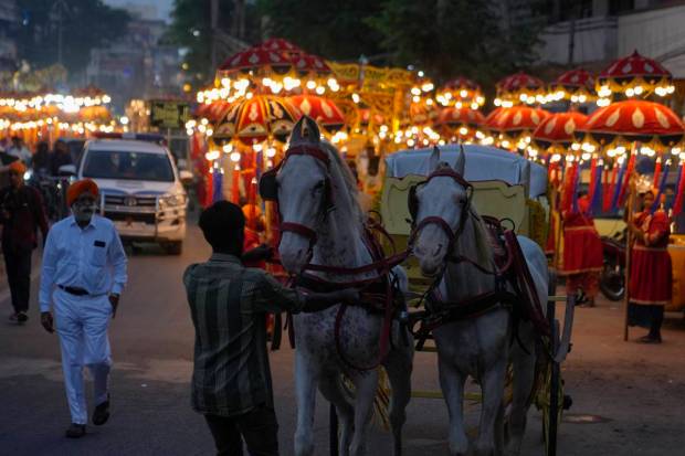 A horse rider pull a cart during a religious procession ahead of the birth anniversary of the first Sikh guru, Guru Nanak in Hyderabad. (AP Photo)