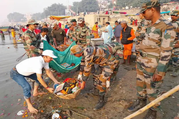 Indian Army personnel participate in a cleanliness drive at the bank of Ganga river before celebration of 'Chhath Puja' festival, in Varanasi. (PTI Photo)