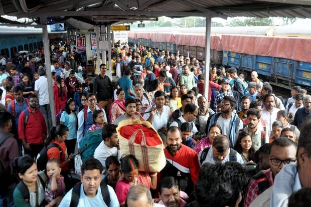 Passengers in large numbers wait to board a train to go to their hometown for the Chhath puja festival, in Ranchi. (PTI Photo)