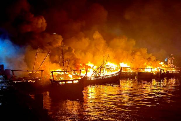Flames and smoke rise after a fire broke out in a jetty area, in Visakhapatnam. (PTI Photo)